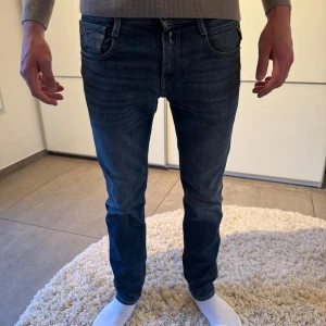 Blå Replay jeansbyxor - Säljer ett par klassiska blå jeans från Replay med fem fickor och snygga söm-detaljer baktill. Jeansen har normal passform och raka ben, perfekt till vardags. Märkeslapp i läder baktill i midjan.