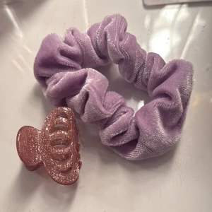Lila sammet scrunchie - Snygg lila scrunchie i mjukt sammetstyg. Perfekt för att sätta upp håret med stil och komfort. Den elastiska designen gör den enkel att använda och passar de flesta hårtyper.