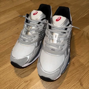 Asics Gel-NYC - vit och grå - Sällsynt chans! Asics Gel-NYC i toppskick, knappt använda. Superbekväm Gel-dämpning och tidlös design som alltid sticker ut. Storlek 45 men passar bra som 44. Perfekta sneakers för vardag eller träning. Missa inte, först till kvarn för de här försvinner snabbt!