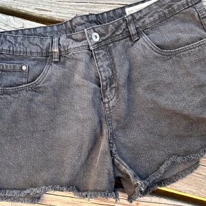 Korta svarta jeansshorts från Esmara!  - Korta svarta jeansshorts i femficksmodell med knapp och dragkedja fram i storlek 42 från Esmara. I mycket gott skick.