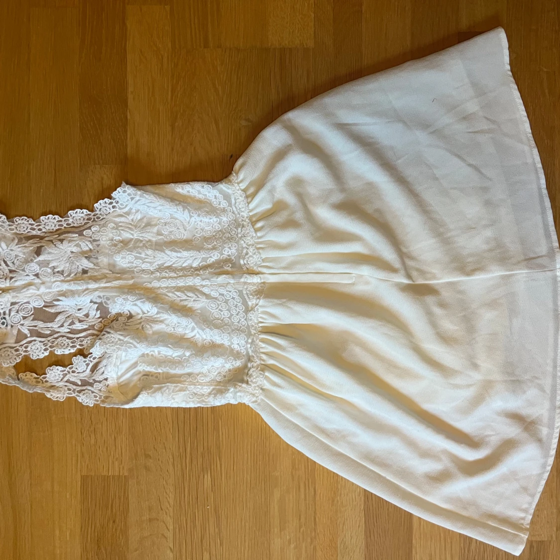 Vit spetsklänning med ärmlös design - 1