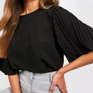 Svart blus - Snygg svart blus från Boohoo. Aldrig använd, endast testad. Nypris 398kr.