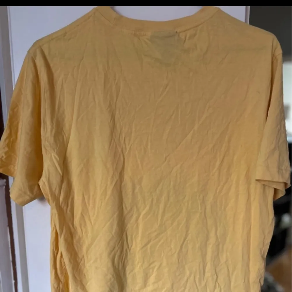 En gul snygg t-shirt med texten ”pursue paradise” använd några gånger!💕. T-paidat.