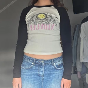 Vit och svart långärmad topp med Nirvana-tryck - Säljer denna ribbade tröja från bershka som bara är använd ett fåtal gånger.