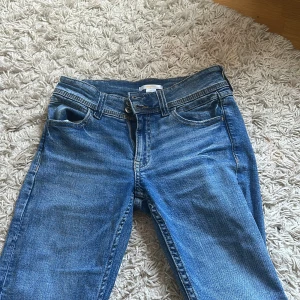Blå jeansbyxor med raka ben - Säljer ett par låg midjade jeans från gina, som knappt är använda. Storleken är 158 men är som 32/34