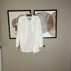 Burberry skjorta - Säljer denna ruskigt stiliga burberry skjorta i storlek L. Den är lite äldre och har krympt en del i tvätten så den passar inte, skulle säga att den passar som S-M