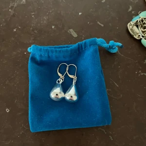Droppformade silverörhängen - Snygga örhängen i droppform med blank, spegelglansig yta i silverfärg. De har smidiga krokar som gör dem enkla att ta på och av. Perfekta för dig som gillar stilrena och moderna accessoarer.