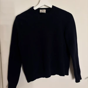 Mörkblå stickad tröja - En stilren mörkblå stickad tröja från Acne Studios. Klassisk rund halsringning och långa ärmar. Passar till allt💕💕ska vara storlek m men tjejen jag köpte den av har krympt den så den är mer en xs/s