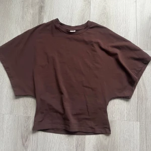 Brun t-shirt från Nelly - Säljer en brun t-shirt från Nelly i storlek S. T-shirten har en lös passform med korta ärmar och rund halsringning. Säljer den då jag inte använder den längre och är då i mycket bra skick,använt 1 gång.