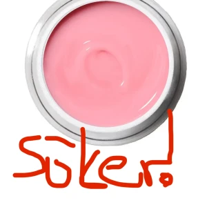 Gellack - Säljer ett läppbalsam i en rund burk med ljusrosa färg. Konsistensen ser krämig ut och burken har en silvrig kant. Perfekt för att återfukta läpparna och ge en lätt glans.