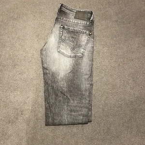 Grå jeans från Pepe Jeans - Snygga grå jeans från Pepe Jeans med en cool tvättad look. De har en klassisk ficksdesign och en knappgylf. Perfekta för en avslappnad stil.