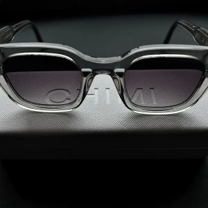 Grå 04 CHIMI - Snygga solglasögon från CHIMI i transparent grå färg med fyrkantig form. Glasögonen har mörka linser och tydlig CHIMI-logga på skalmen. Solglasögonen varsamt använda men i bra skick, fodralet har skada på insidan men inget tydlig eller som påverkar glasögonen. 