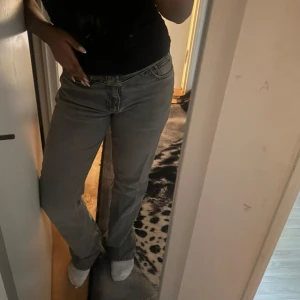 Grå raka jeans med normal midja - Säljer ett par grå jeans med rak passform och klassisk femficksdesign. Jeansen har normal midja och stängs med dragkedja och knapp. Perfekta till en avslappnad stil och funkar året runt. Materialet är klassisk denim i bomull.