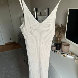 Beige ribbad långklänning från Gina Tricot - Säljer en beige ribbad långklänning från Gina Tricot med smala axelband och v-ringning. Sitter tajtare och känns mer som en s/xs! 💞