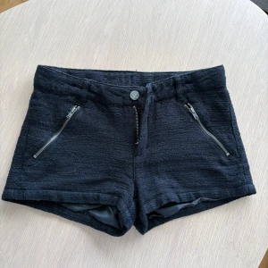 Svarta shorts från Lindex med dragkedjor - Snygga svarta shorts från Lindex i grovvävt tyg med två coola dragkedjor framtill. Passar mig som brukar ha strl 32-34🩷🩷
