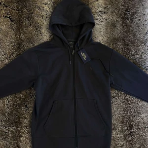 Polo Ralph Lauren hoodie (Sällsynt) - Svart hoodie från Polo Ralph Lauren i S storlek, Hoodien är väldigt sällsynt med black logo. Perfekt för Skolstarten eller en chill Hoodie. Helt nytt skick (10/10)🤩och är inte använd alls. Pris kan diskuteras! vid bundle och snabb affär☺️ tveka inte och kontakta vid intresse👌 frågor om passform och bilder? Kontakta mig🫡