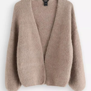 Beige stickad kofta från Lindex - Säljer en helt ny, Supermjuk och fluffig beige stickad kofta från Lindex. Koftan har en öppen front utan knappar, avslappnad passform och långa ärmar. Perfekt att slänga på sig över en t-shirt för en chill och snygg look. Skicka för mer bilder.