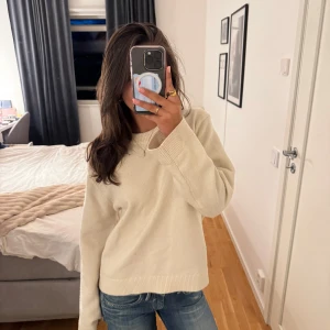 Beige stickad tröja från Gina Tricot - Enkel och stilren beige stickad tröja från Gina Tricot i storlek XS. Tröjan har rund halsringning, långa ärmar och ribbade muddar vid ärmslut och nederkant. Perfekt att matcha med jeans för en clean look. Tröjan har några fläckar som man kan se på bilderna💖