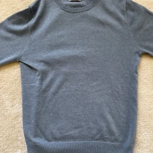 Ljusblå tröja från Bläck - Säljer en stilren ljusblå tröja från Bläck i storlek S. Tröjan har en klassisk rund hals och långa ärmar, perfekt för en minimalistisk look. Passar bra till både jeans och chinos.