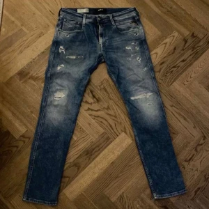 Replay jeans  - Säljer dessa snygga blåa Replay jeans med slitningar. Modellen är Anbass i storleken 32 men passar även 31. 9/10 skick använt 4-6 gånger. Priset är hugget i sten då priset är så lågt. Hör av dig vid funderingar!