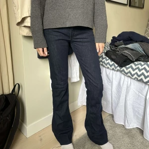 Mörkblå bootcut jeans - Snygga mörkblå bootcut jeans med hög midja. Perfekta för en stilren look med en klassisk passform. Har sytt bootcuten själv.