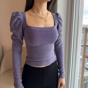 Lila glittrig topp - Glittrig topp med puffiga axlar och lång ärm. Tight passform i strl XS. Köpt från H&M divided ✨