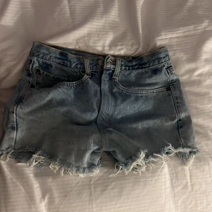 Ljusblå jeansshorts med fransar från Levi's - Säljer ett par ljusblå jeansshorts från Levi's som jag köpt från plock sen innan, kommer inte till användning nåmer
