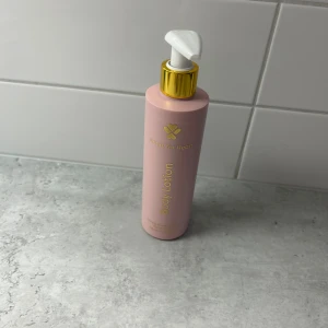 Heart for Heart Body Lotion rosa - Säljer en rosa body lotion från Heart for Heart med praktisk pump och gulddetaljer. Flaskan är stilren och passar perfekt i badrummet. Doften är mild och fräsch, och lotionen återfuktar huden utan att kännas kladdig. Helt ny