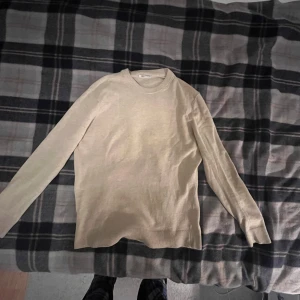 Beige stickad tröja från Zara - Snygg beige stickad tröja från Zara med rund hals och långa ärmar. Enkel och clean design som funkar till många olika stilar. Mjuk och skön kvalitet i stickat material, perfekt för lager-på-lager under hösten och vintern.