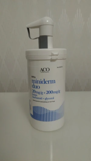 ACO Miniderm Duo kräm 500g - Stor pumpflaska med ACO Miniderm Duo kräm, innehåller karbamid och glycerol för återfuktning av torr hud. Vit plastflaska med blå detaljer och praktisk pump. Perfekt för daglig hudvård och enkel applicering.