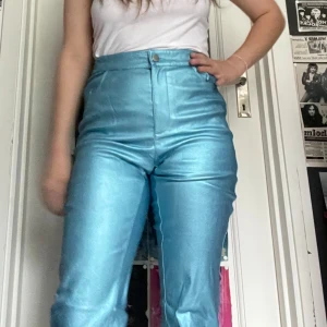 Glansiga byxor från NA-KD - Snygga byxor, stretchiga men tycker de är små i storleken och skulle passa en i storlek 34 bättre än 36. Det är även lite bootcut dock syns det ej på mig då jag är lite för kort för dessa. Jag kan mötas upp i Uddevalla centrum, annars fraktar jag gärna. Köparen står för frakten. (Står ej för postens slarv) katt finns i hemmet. 