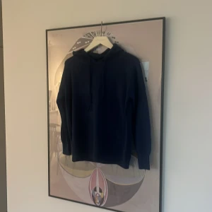 Merinoull hoodie  - En stilren mörkblå merinoull hoodie. Den passar dig som är 170-175