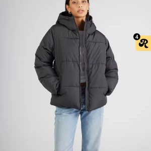 Mörkgrå pufferjacka med huva - Säljer en mörkgrå pufferjacka med huva och dragkedja framtill. Jackan har snörning i nederkant för att justera passformen och är quiltad med breda kanaler. Perfekt för kalla dagar och har en loose fit som ger en chill vibe.