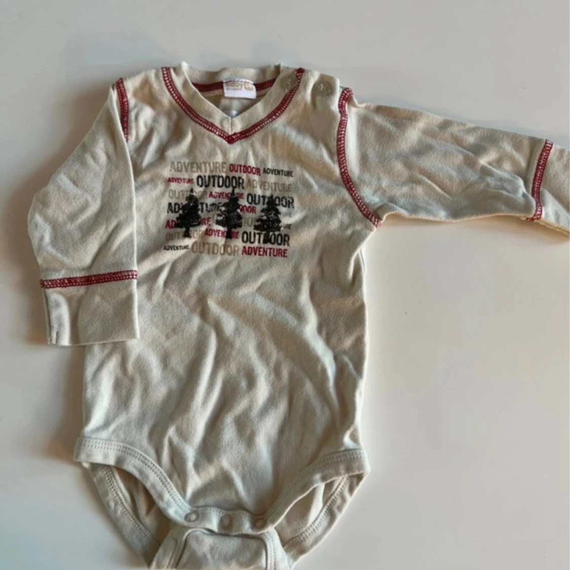 Beige långärmad body med tryck