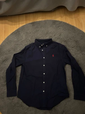 Ralph Lauren linneskjorta  - Helt ny, storlek L men sitter mer som M. Linneskjorta. Färg blå. Hör av dig vid minsta lilla fundering! 