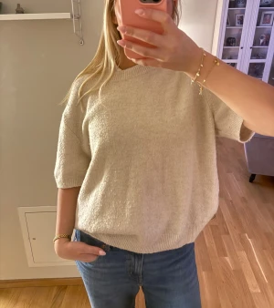 Beige stickad tröja med kort ärm - Mysig beige stickad tröja med korta ärmar. Från hm. Väldigt liten i storlek , är vanligtvis en S