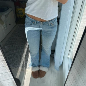 Levis bootcut jeans - Säljer ett par Levis jeans i ljusblå tvätt med bootcut passform och låg midja. Nersprättade där nere så att de passar mig som är 165 (kan även passa längre) men är annars i väldigt bra skick. midjemått 38 cm.