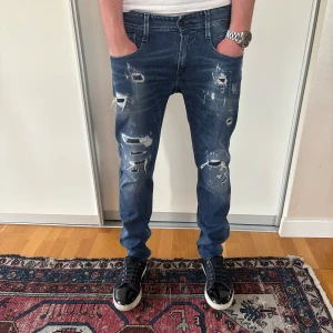 Mörklblåa replay anbass me feta slitningar  - Säljer ett par mörkblå jeans med feta slitningar från replay i storlek 30/31!Vid funderingar va inte rädd för att fråga!