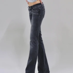 G rise jeans - Snygga svarta bootcut jeans med låg midja och klassisk femficksdesign. Jeansen har en lätt tvättad look och sitter tajt över låren innan de blir vidare nedtill. Perfekta för dig som gillar en cool och avslappnad stil.