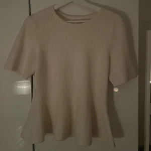superfin stickad tshirt med volang - säljer då den ej kommer till användning, superfin! Färgen vit/beige. Passar M/L