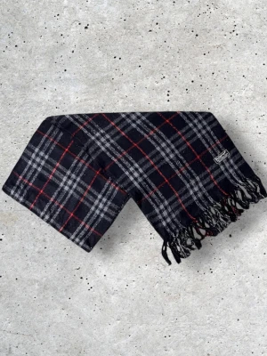 Mörkblå Burberry halsduk - Säljer en snygg Burberry halsduk med det ikoniska rutmönstret. Tillverkad i 100% mjuk och värmande ull.   🧵 Skick: Mycket fint skick, varsamt använd 🌟 Känsla: Mjuk, varm och följsam 📦 Frakt: Skickas tryggt inom 24h 📏 Mått: Längd-150cm, Bredd-30cm Pris kan diskuteras!