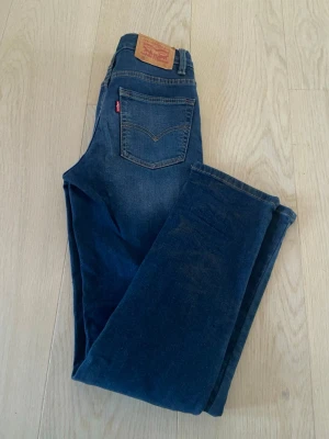 Levi's 502 mörkblå jeans - Säljer ett par Levi's 502 jeans i mörkblå tvätt med raka ben och fem fickor. Jeansen har den ikoniska läderpatchen bak och röd Levi's-tag på bakfickan. 