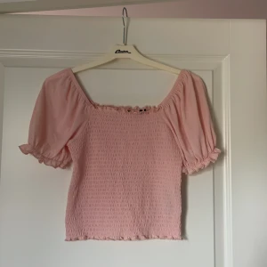 Rosa topp från Vero Moda - Supersöt ljusrosa topp från Vero Moda med puffiga ärmar. 