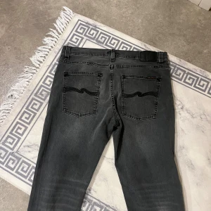 Svarta jeans från Nudie Jeans, 34/32 -  Säljer ett par svarta jeans från Nudie Jeans i storlek 34/32.  Byxorna är helt nya har använt de två gånger priset kan diskuteras 