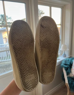 Beige Saint Laurent sneakers mocka - Snygga beige sneakers från Saint Laurent med handskriven logga på sidan. Skorna har rund tå, platt sula och är tillverkade i mjuk mocka med snörning framtill. Perfekt för dig som gillar stilrena och exklusiva sneakers med en unik touchPriset är diskuterbart!!