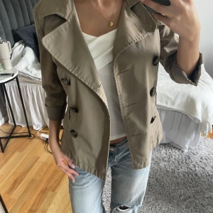 Trenchcoat  - Jätte snygg trenchcoat med trekvarts ärmar. Jätte fint skick. Säljer då den inte kommer till användning. 