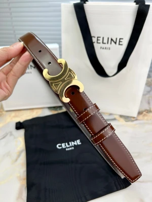 Brunt läderbälte från Celine - Snyggt brunt bälte från Celine i glansigt läder med vita kontrastsömmar. Bältet har ett unikt guldspänne i form av Celines ikoniska Triomphe-logga. Perfekt accessoar för att lyfta din outfit med en lyxig touch.