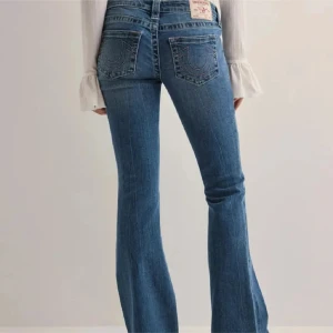 True Religion bootcut jeans blå - Snygga blå jeans från True. Modellen har låg midja och bootcut-ben, tillverkade i mjukt denim med lätt tvättad look. Köpta på Nelly storlek 24. Använder nästan aldrig dem för de är för långa för mig som är 157cm. 