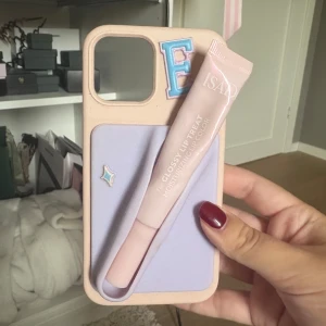 Rosa Mobilskal läppglans hållare iPhone 12 Pro - Jättenajs mobilskal från holdit med ett läppglans hållare köpt från ett UF företag ❤️❤️ passar iPhone 12 pro, säljer då jag har ny mobil 🫰 nypris ca 400 totalt!!