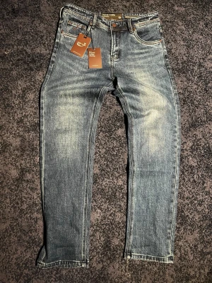 Blå jeans från Jacob Cohen - Snygga blå jeans från Jacob Cohen med klassisk femficksdesign och tydliga slitningar. Jeansen har en rak passform och är tillverkade i ett mjukt denimtyg. Storlek 30.    Pris ej hugget i sten kom gärna med frågor och funderingar:)